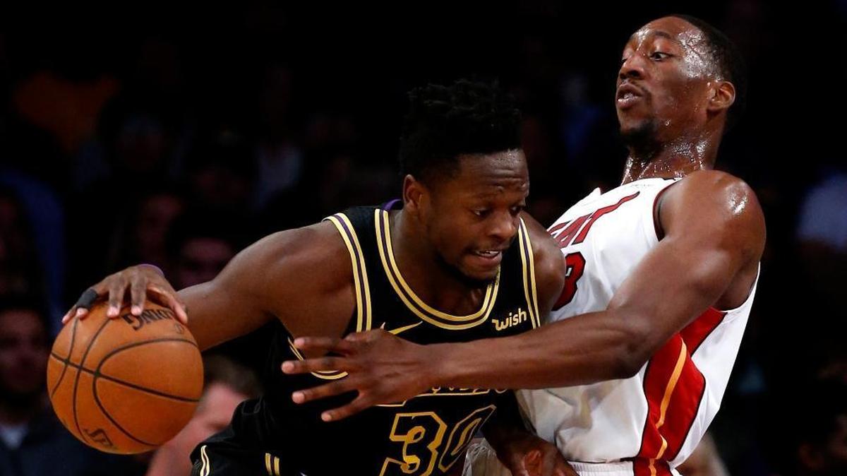 Los Angeles Lakers forward Julius Randle, left, drives against Miami Heat center Bam Adebayo during the first half of an NBA basketball game Friday, March 16, 2018, in Los Angeles.