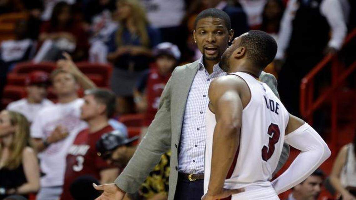 
Miami Heat center Chris Bosh, left, talks with guard Dwyane Wade (3) during the second half of an NBA basketball game against the Memphis Grizzlies, Saturday, Dec. 27, 2014, in Miami. The Grizzlies defeated the Heat 103-95.
