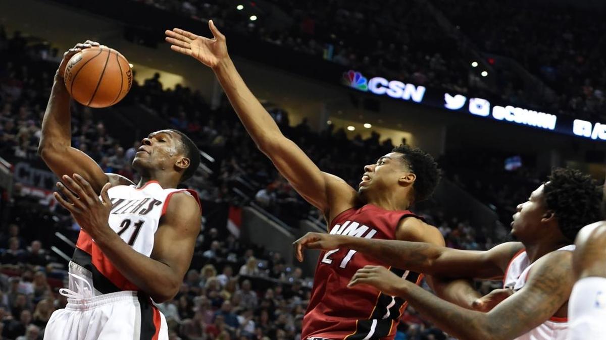 Portland forward Noah Vonleh grabs a rebound in front of Miami center Hassan Whiteside during Saturday’s late game.