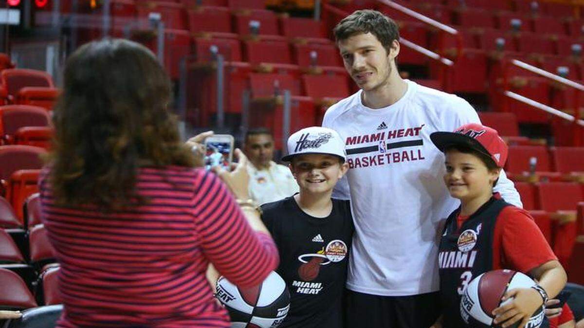 
The Miami Heat's Goran Dragic takes pictures with fans Dylan Martin, left, and Sebastian Tanner before the game against the Toronto Raptors at AmericanAirlines Arena in Miami on Saturday, April 11, 2015. 
