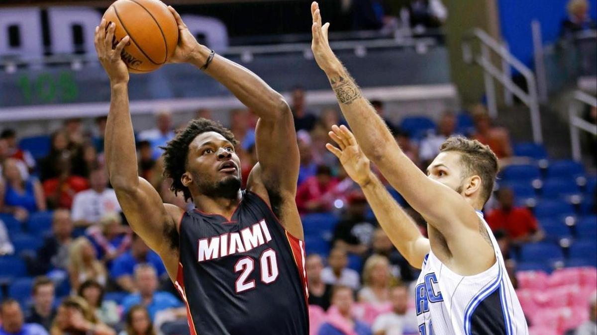 
Miami Heat forward Justise Winslow (20) goes up for a shot against Orlando Magic guard Evan Fournier, right, during the first half of an NBA preseason game, Tuesday, Oct. 13, 2015, in Orlando, Fla. 
