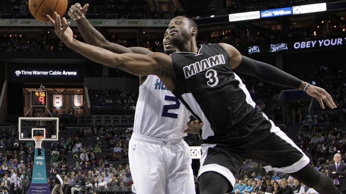 Miami Heat’s Dwyane Wade (3) drives past Charlotte Hornets’ Marvin Williams (2) in the first half in Charlotte, N.C., Wednesday, Dec. 9, 2015.