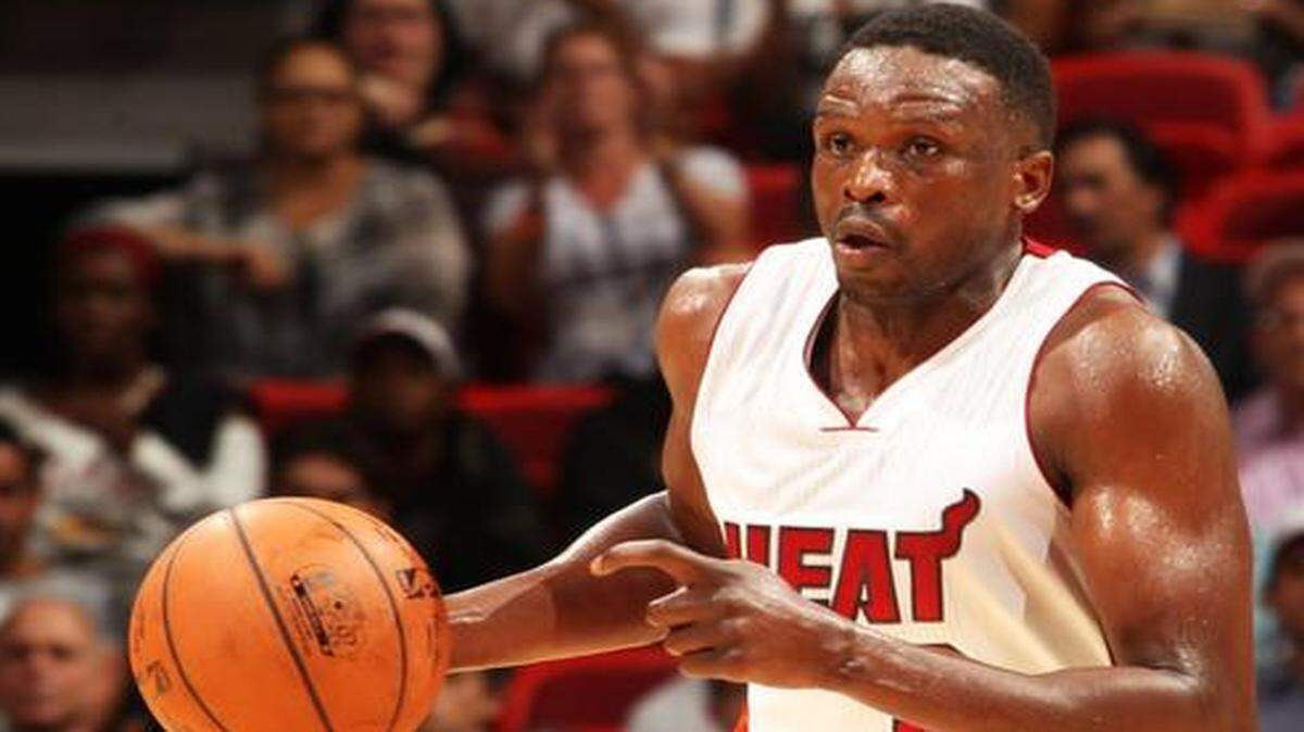 
Luol Deng of the Miami Heat handles the ball against the Houston Rockets at the AmericanAirlines Arena in Miami, Florida on Nov. 2, 2014.
