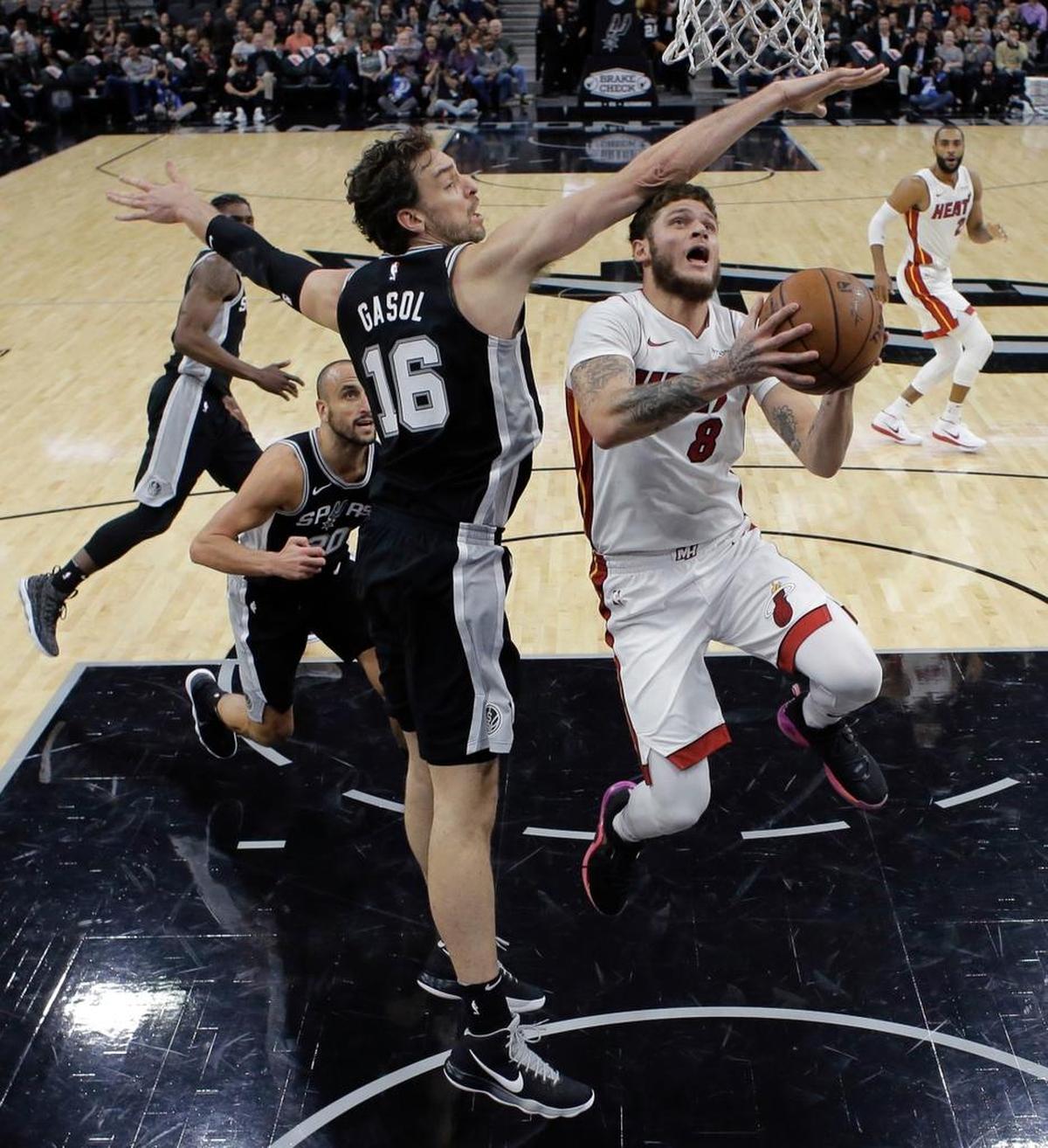 Miami Heat guard Tyler Johnson (8) drives to the basket against San Antonio Spurs center Pau Gasol (16) during the first half of an NBA basketball game, Wednesday, Dec. 6, 2017, in San Antonio.
