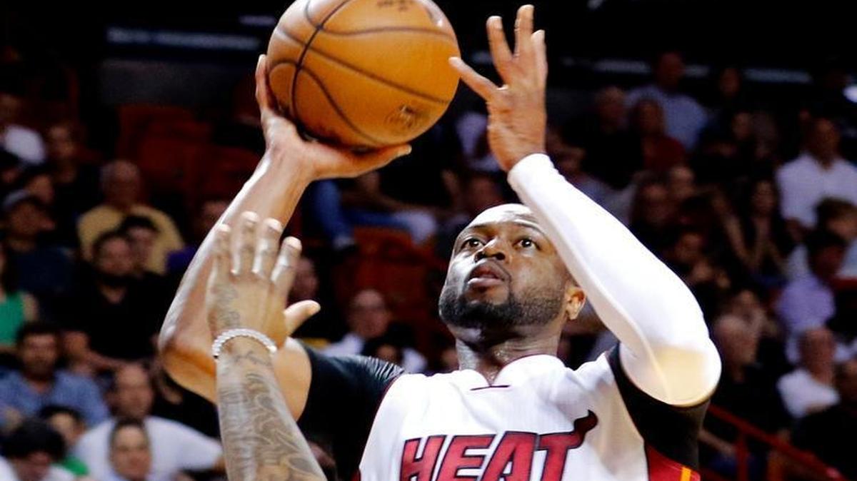 Miami Heat guard Dwyane Wade (3) shoots over Brooklyn Nets guard Sean Kilpatrick (6) in the second half of an NBA basketball game, Monday, March 28, 2016, in Miami. Miami won the game 110-99.