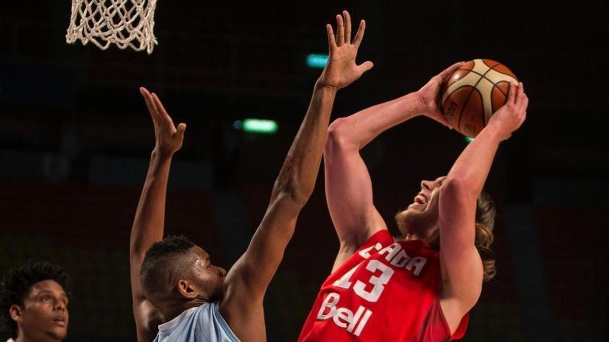 Canada's Kelly Olynyk, right, shoots over Cuba's Jasiel Rivero, during a FIBA Americas Championship basketball game in Mexico City, Wednesday, Sept. 2, 2015.
