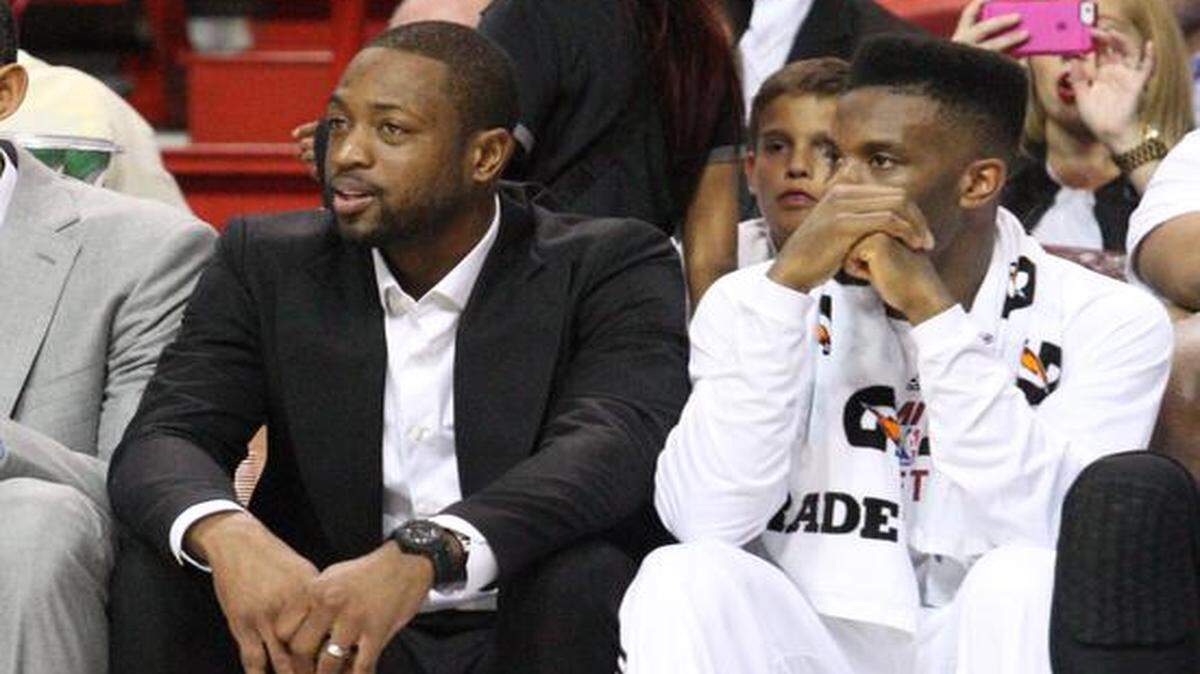 
Miami Heat guard Dwyane Wade sits on the bench along with Norris Cole during their game against the Milwaukee Bucks at the AmericanAirlines Arena in Miami on Nov. 16, 2014.
