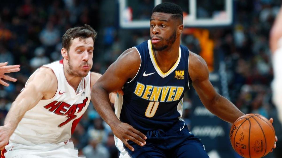 Denver Nuggets guard Emmanuel Mudiay, right, drives the lane past Miami Heat guard Goran Dragic, of Slovenia, during the second half of an NBA basketball game Fri., Nov. 3, 2017, in Denver. The Nuggets won 95-94.