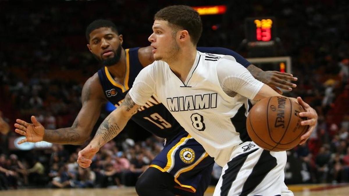 Miami Heat guard Tyler Johnson drives against Indiana Pacers forward Paul George during the first quarter of an NBA basketball game at AmericanAirlines Arena in Miami on Wednesday, Dec. 13, 2016.