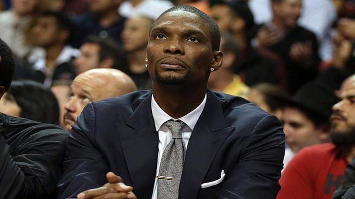 
Miami Heat’s Chris Bosh sits on the bench in the fourth quarter of the Heat’s game against the Utah Jazz at AmericanAirlines Arena in Miami on Wednesday, December 17, 2014.
