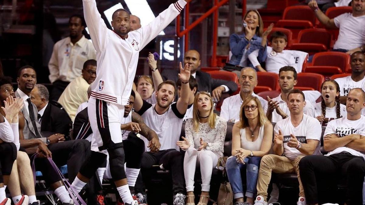 Dwayne Wade lifts his hands in the air after starters sit on the bench and a fresh squad scores late in the fourth quarter. On Sun., April 17, 2016 Miami Heat played the first half against the Charlotte Hornets in the first round of the NBA playoffs inside the American Airlines Arena in Miami, Florida.
