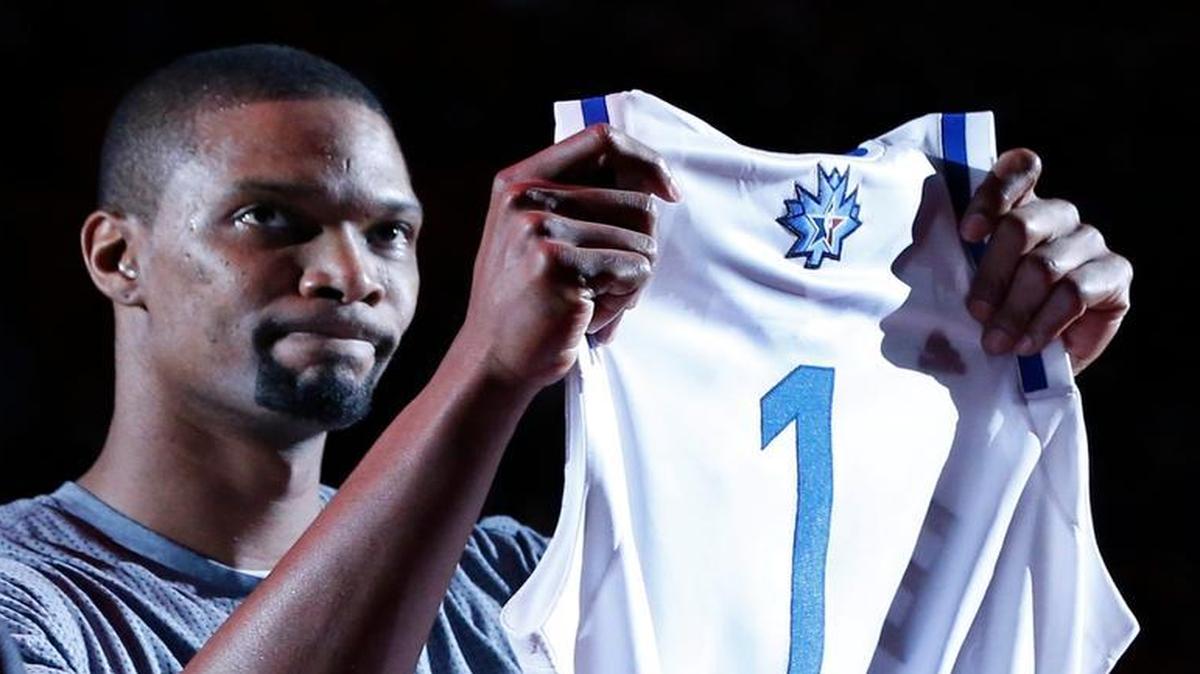 Miami Heat forward Chris Bosh holds up a jersey for the NBA All-Star Game, presented to him before the start of an NBA basketball game against the San Antonio Spurs, Tuesday, Feb. 9, 2016, in Miami.