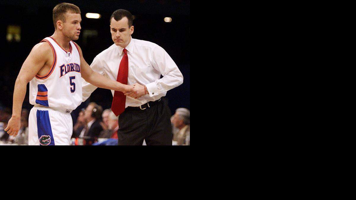 
Florida coach Billy Donovan welcomes guard Teddy Dupay off the court near the end of the Gator's 69-56 win in the first round of the NCAA tournament at the Louisiana Superdome Friday, March 15, 2001.
