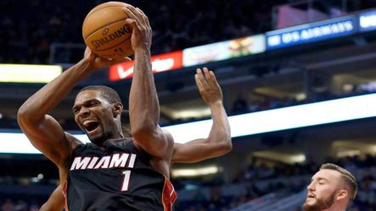 
The Heat's Chris Bosh grabs a rebound in front of the Suns' Miles Plumlee during the second half of Tuesday’s game in Phoenix. 
