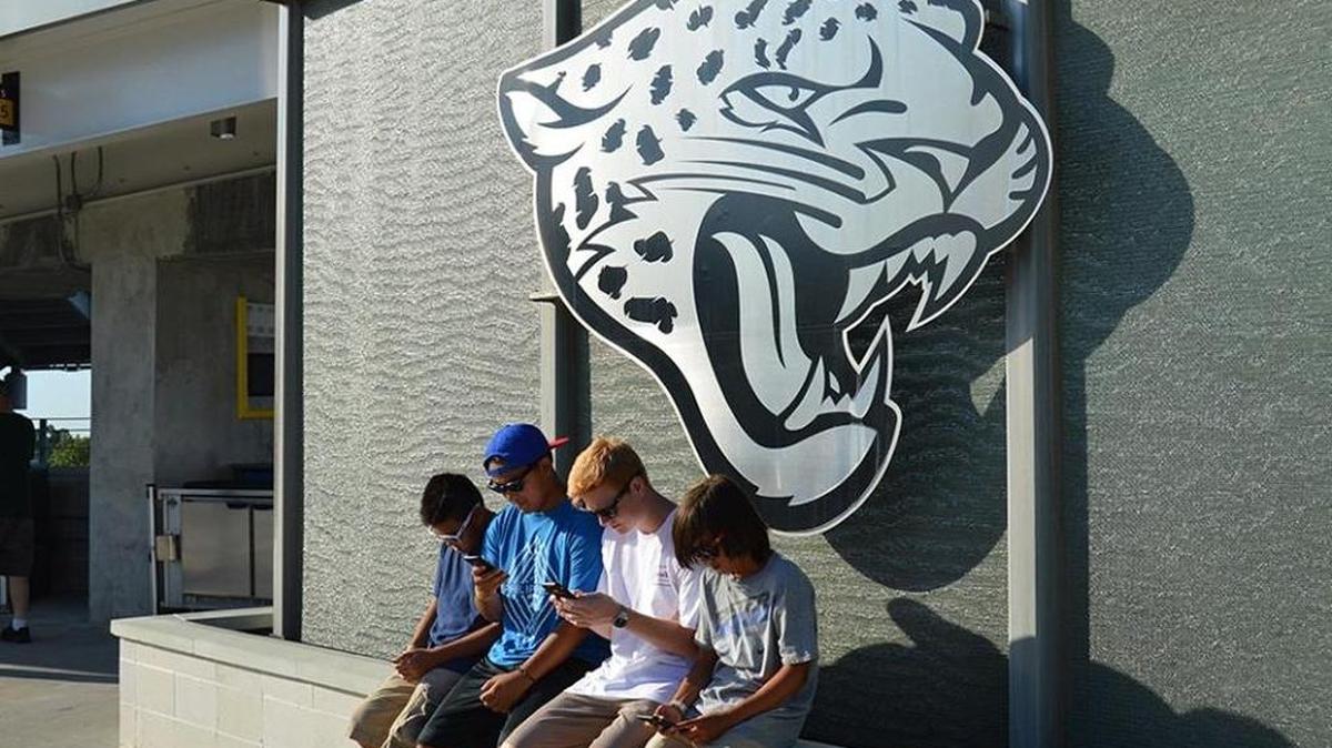 Fans take a breather while taking part at the Jacksonville Jaguars’ Pokémon Safari at EverBank Field on Monday evening.