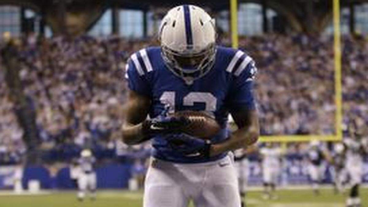 
Indianapolis Colts receiver T.Y. Hilton cradles the football after scoring on a 73-yard touchdown reception against the Jacksonville Jaguars on Sunday, Nov. 23, 2014 in Indianapolis. Hilton wife gave birth to a daughter early Sunday morning.
