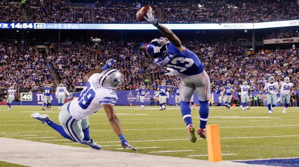 
New York Giants wide receiver Odell Beckham Jr. makes a one-handed catch for a touchdown against Dallas Cowboys cornerback Brandon Carr on Sunday, Nov. 23, 2014, in East Rutherford, N.J. 
