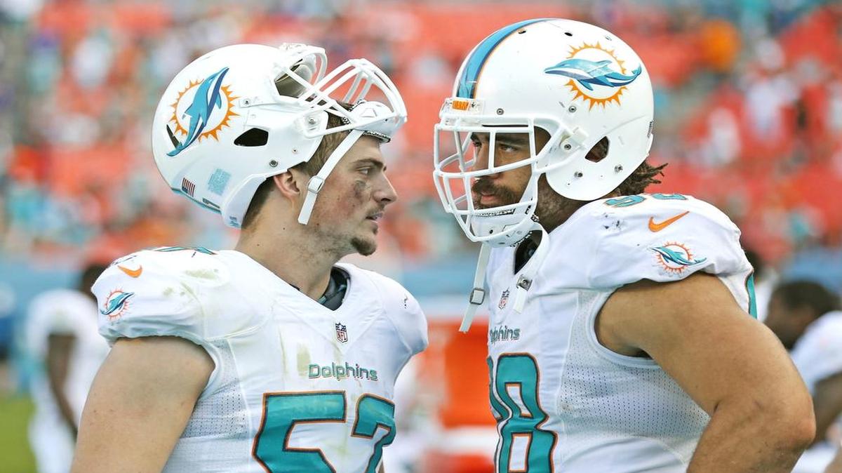 
Miami Dolphins outside linebacker Jordie Tripp (57) and former Dolphins defensive tackle Jared Odrick (98) on the sidelines late in the fourth quarter as the Miami Dolphins host the Baltimore Ravens on Sunday, December 7, 2014.
