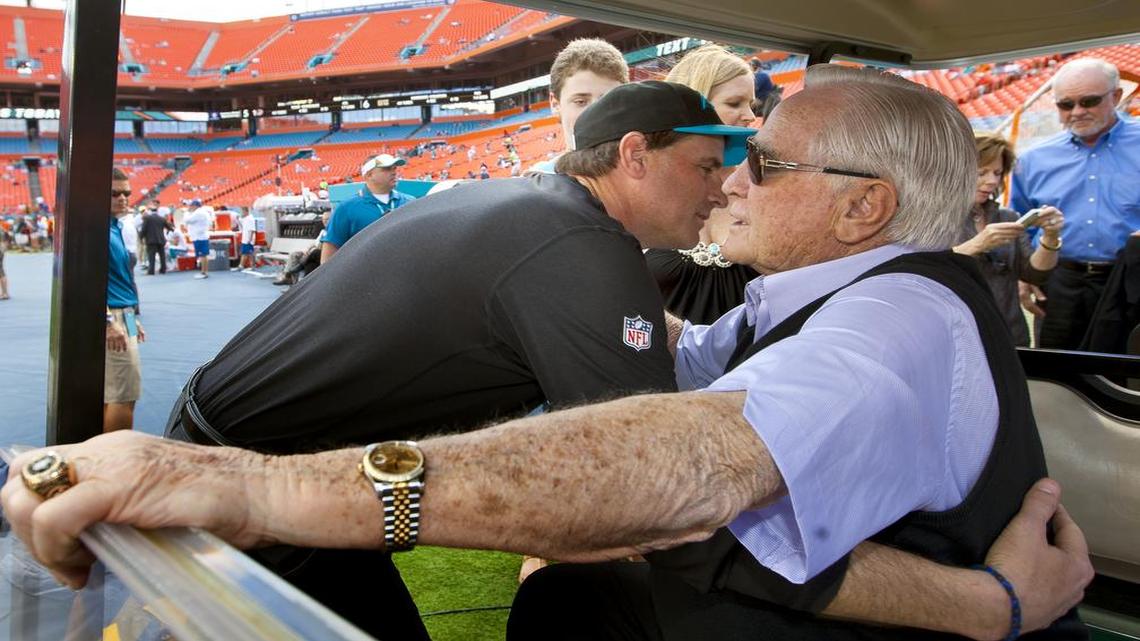 Carolina Panthers offensive coordinator Mike Shula hugs his dad Don Shula on the sideline before the game against the Miami Dolphins at Sun Life Stadium in Miami Gardens on November 24, 2013.