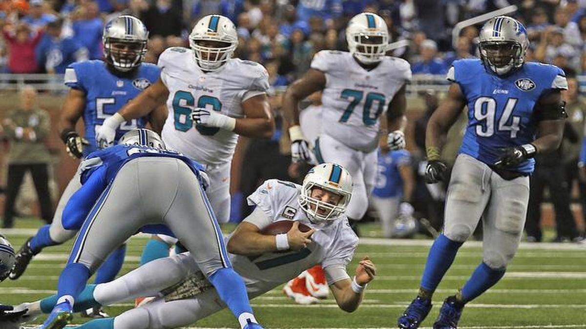 
Miami Dolphins quarterback Ryan Tannehill is tackled by Detroit Lions defensive end George Johnson in the third quarter of their game at Ford Field in Detroit on Nov. 9, 2014.
