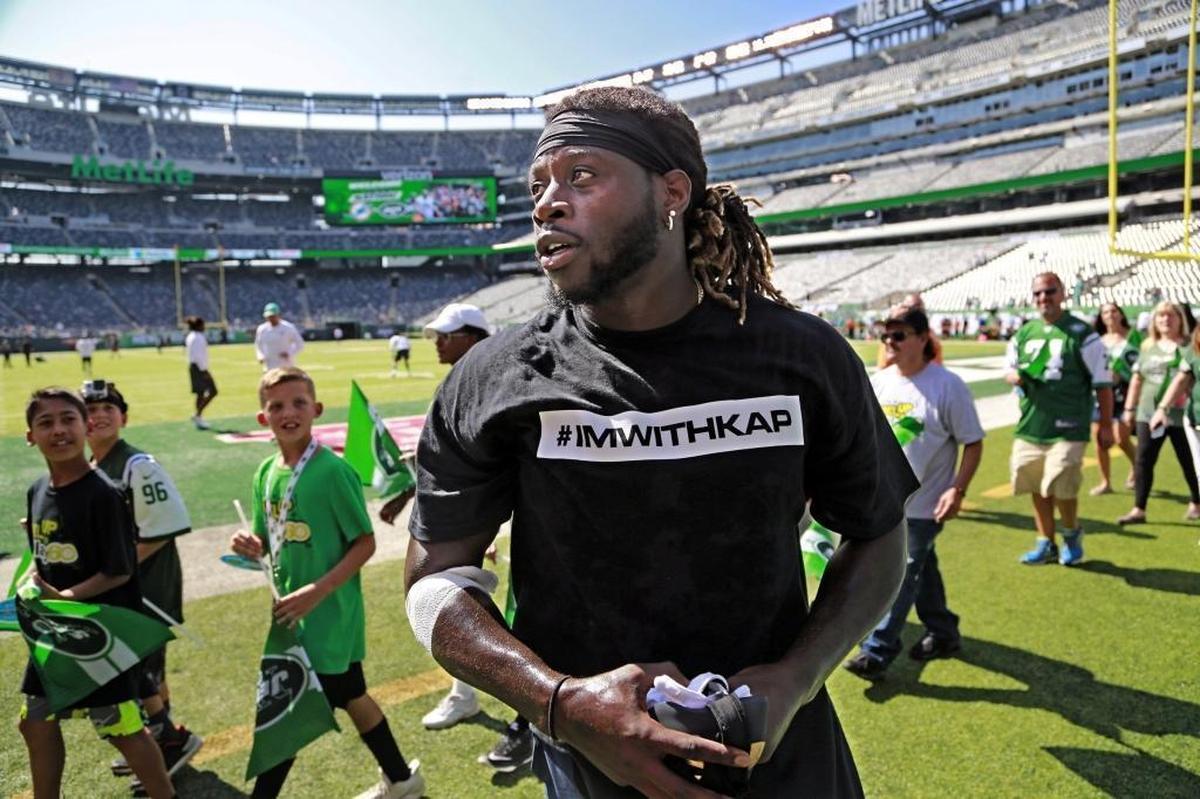 Miami Dolphins running back Jay Ajayi and several other Dolphin players wear t-shirts in support of Colin Kaepernick Sunday.