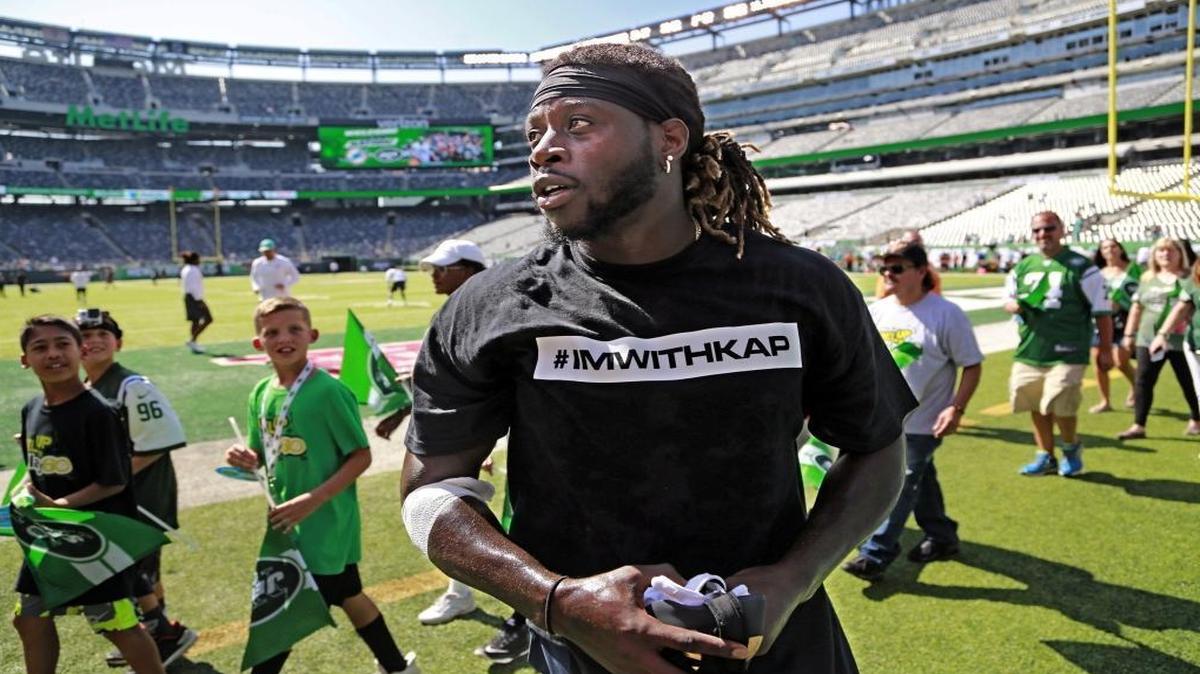 Miami Dolphins running back Jay Ajayi and several other Dolphin players wear t-shirts in support of Colin Kaepernick Sunday.