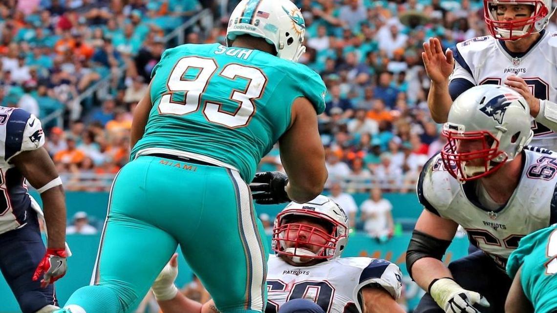 Ndamukong Suh knocks over Patriots center David Andrews and draws an offsides penalty Sunday.