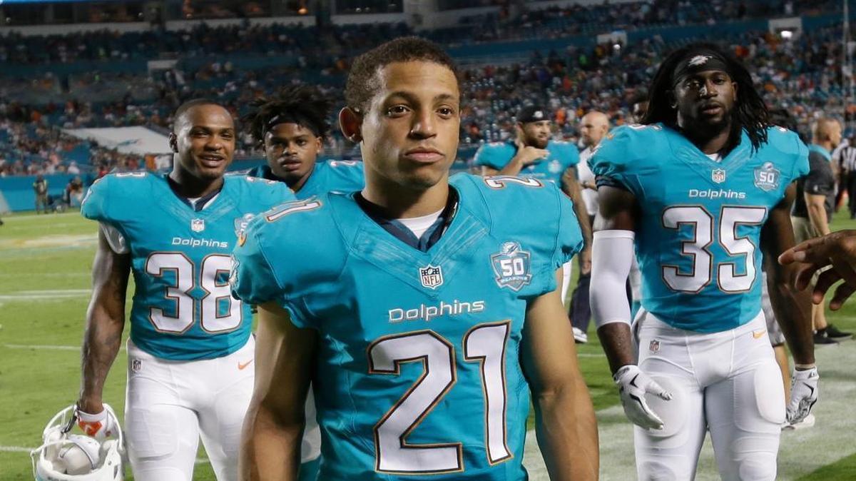 
Miami Dolphins players: cornerback Brent Grimes (21) defensive back Don Jones (38) and cornerback Walt Aikens (35) walk off the field after the first half of an NFL football preseason game against the Atlanta Falcons, Saturday, Aug. 29, 2015 in Miami Gardens, Fla. 
