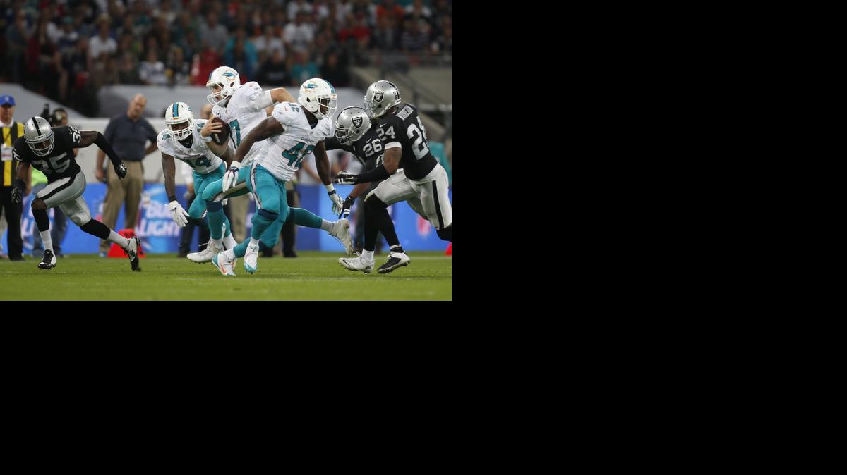
Miami Dolphins' Ryan Tannehill (17) rushes during the second half of an NFL football game against the Oakland Raiders, Sunday, Sept. 28, 2014, at Wembley Stadium in London.
