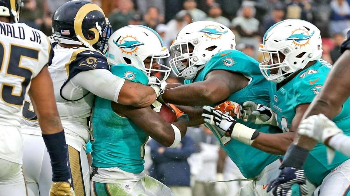 Miami Dolphins Jarvis Landry is pushed into the endzone by Ja'Wuan James (70) and Jermon Bushrod (74) to score a touchdown in the fourth quarter as they defeat and Los Angeles Rams at the Los Angeles Memorial Coliseum in Los Angeles, California, November 20, 2016.