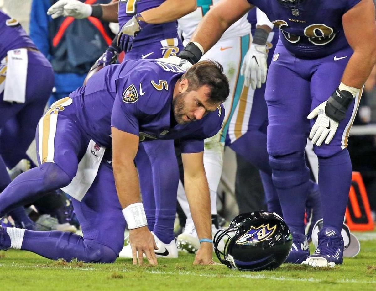 Baltimore Ravens quarterback Joe Flacco (6) gets up slowly after being hit by Miami Dolphins Kiko Alonso in the second quarter at the M&T Bank Stadium in Baltimore, Maryland, Oct. 26, 2017.
