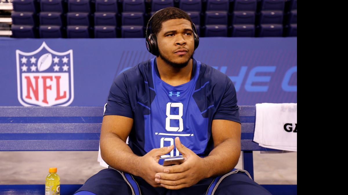 
La'el Collins sits on a bench at the NFL football scouting combine in Indianapolis on Feb. 20, 2015.
