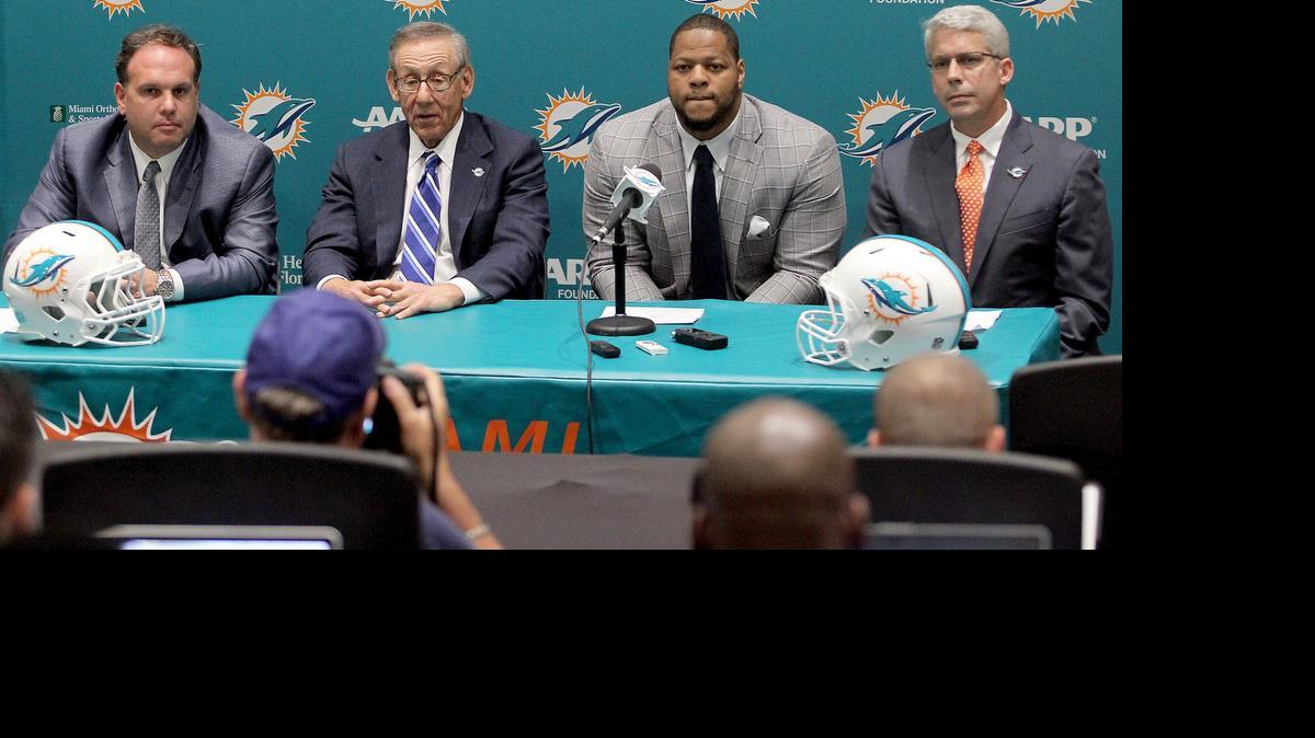 
From left, Miami Dolphins Executive Vice President, Football Operations Mike Tannenbaum, owner Stephen Ross and general manager Dennis Hickey, right, introduce Ndamukong Suh at a press conference Wednesday March 11, 2015.
