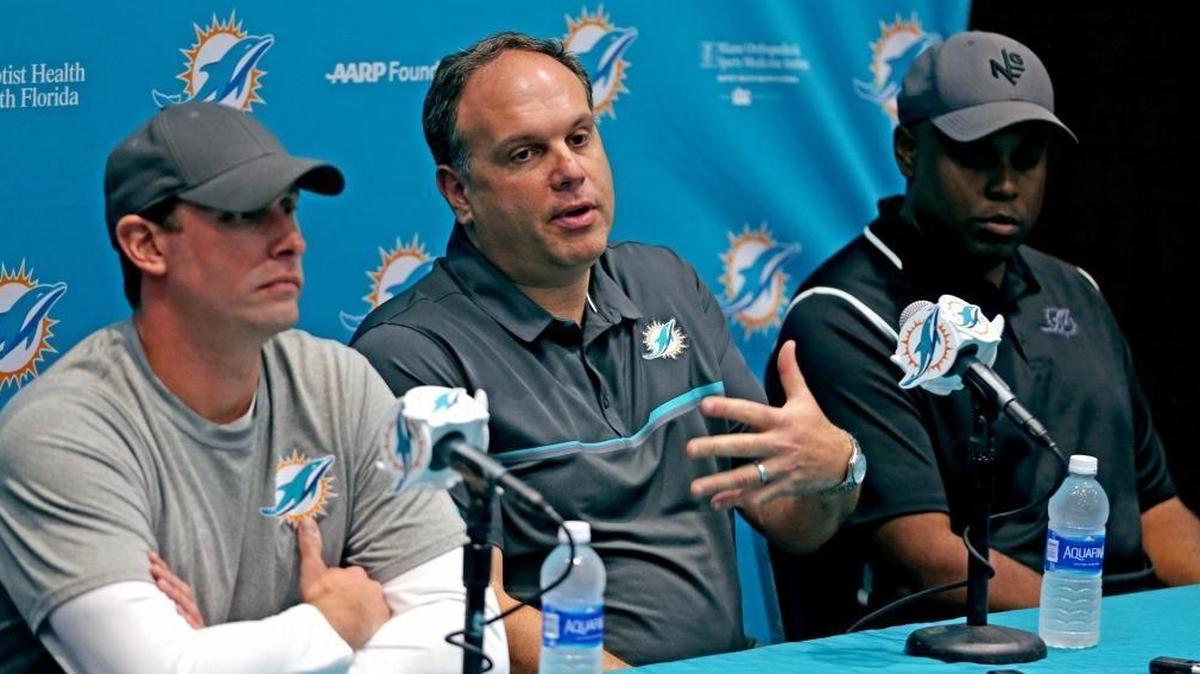 Miami Dolphins’ Mike Tannenbaum, VP of operations (center) with coach Adam Gase and GM Chris Grier in 2018. Tannebaum, on the new Greg Cote Show podcast, discusses his uncomfortable departure from team and more.
