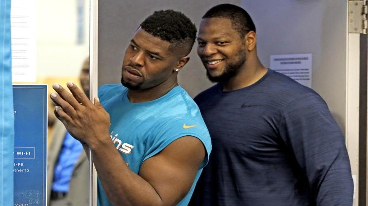 Miami Dolphins defensive end Cameron Wake, at left and defensive tackle Ndamukong Suh, right, keep things light at a news conference during Dolphins minicamp on June 14.