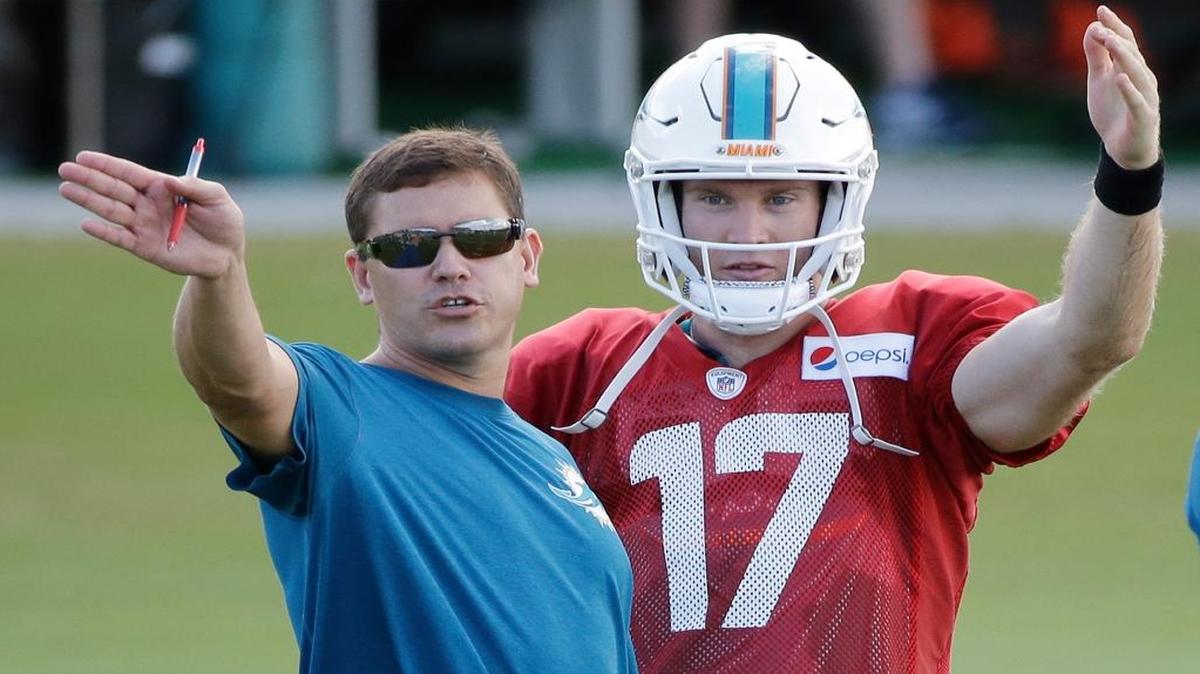 
Miami Dolphins quarterback Ryan Tannehill talks with offensive coordinator Bill Lazor during training camp practice, Tuesday, Aug. 11, 2015 in Davie, Fla.
