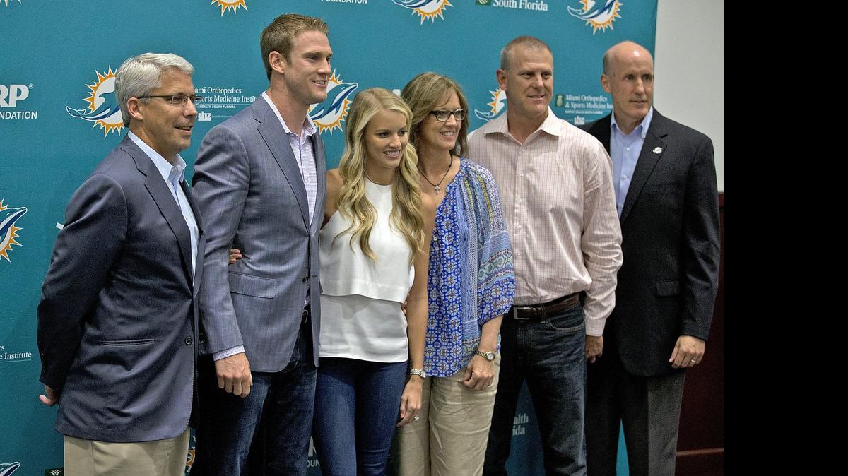 
Miami Dolphins quarterback Ryan Tannehill, second from left, poses with GM Dennis Hickey, left, Tannehill’s wife Lauren, his parents Cheryl and Tim and coach Joe Philbin during a news conference to announce his new $96 million contract Tuesday, May 19, 2015.
