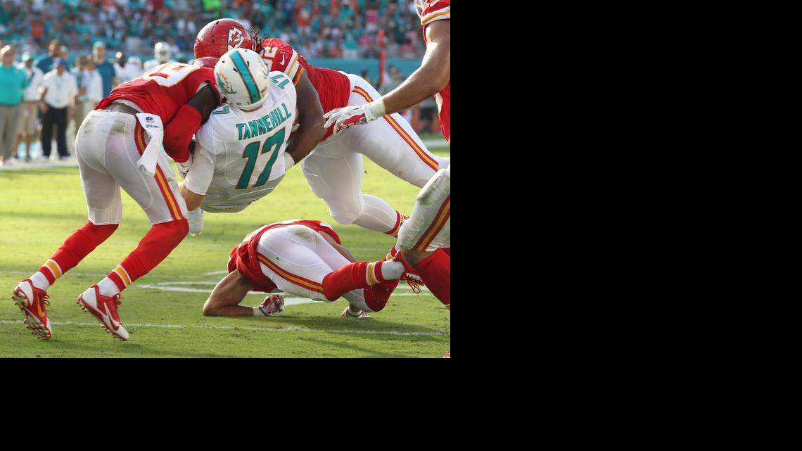 
Miami Dolphins quarterback Ryan Tannehill gets squeezed between Kansas City Chiefs defenders Husain Abdullah and Dontari Poe as Tannehill moves the ball to help setup a field goal at the end of the second quarter at Sun Life Stadium in Miami Gardens, Fla., on Sunday, Sept. 21, 2014. 
