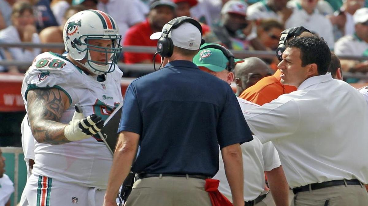 
Miami Dolphins guard Richie Incognito talks with coach Joe Philbin after Incognito was hit with a penalty in the second quarter against the Tennessee Titans at Sun Life Stadium on Nov. 11, 2012.
