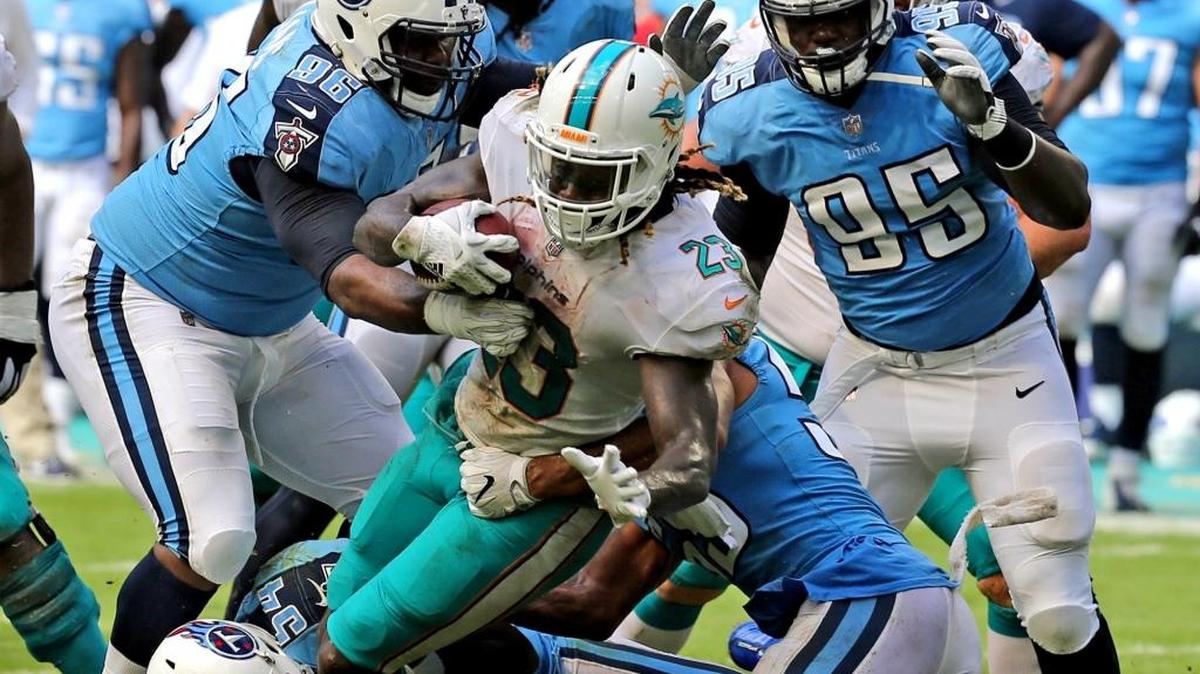 Miami Dolphins Jay Ajayi (23) fights his way through the Tennessee Titans defense in the fourth quarter at Hard Rock Stadium in Miami Gardens, Florida, Oct. 8, 2017.