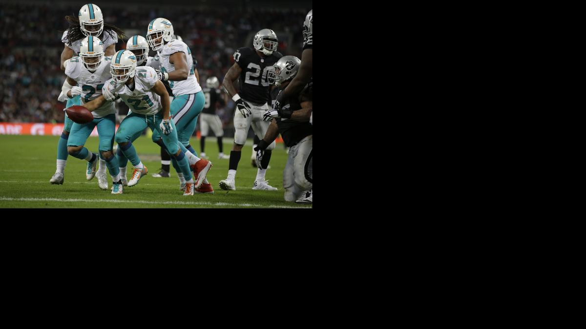 
Miami Dolphins' Brent Grimes celebrates after scoring a touchdown during the second half of an NFL football game against the Oakland Raiders, Sunday, Sept. 28, 2014, at Wembley Stadium in London. 
