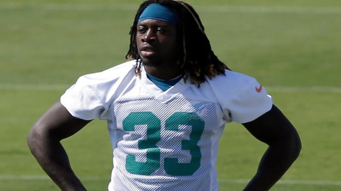 
Miami Dolphins' Jay Ajayi takes a break during NFL football rookie minicamp, Saturday, May 9, 2015, in Davie, Fla. 
