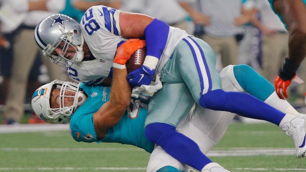 Cowboys tight end Jason Witten, top, is brought down by the Dolphins’ Kiko Alonso after a reception in a preseason game in Arlington, Tx. Witten retired this spring and is joining ESPN as the lead analyst on Monday Night Football, replacing new Raiders coach Jon Gruden.