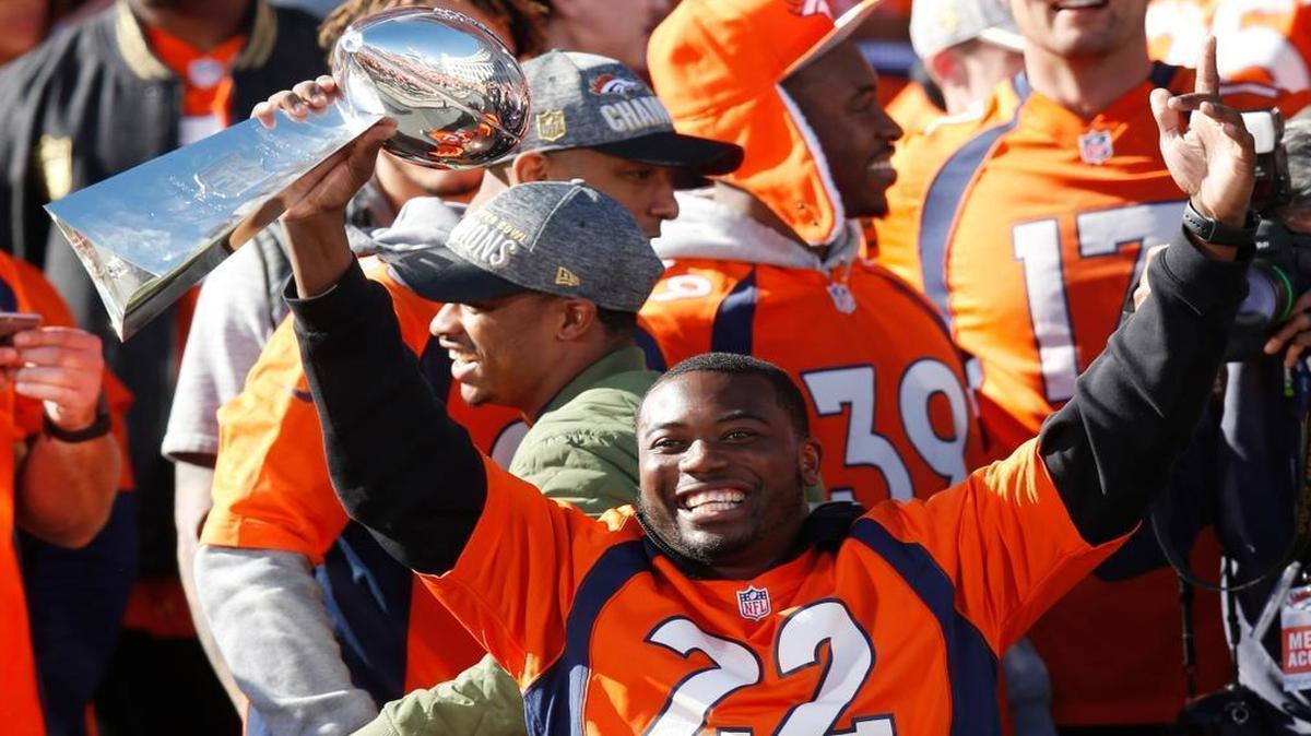 Denver Broncos running back C.J. Anderson holds the Lombardi Trophy at a rally following a parade through downtown Feb. 9, 2016 in Denver. He’s visiting the Dolphins Thursday.