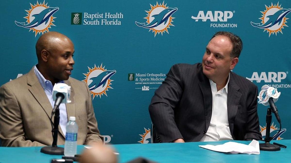 Miami Dolphins general manager Chris Grier, left, and Mike Tannenbaum, executive vice president of football operations, talk draft strategy during Friday’s predraft news conference.
