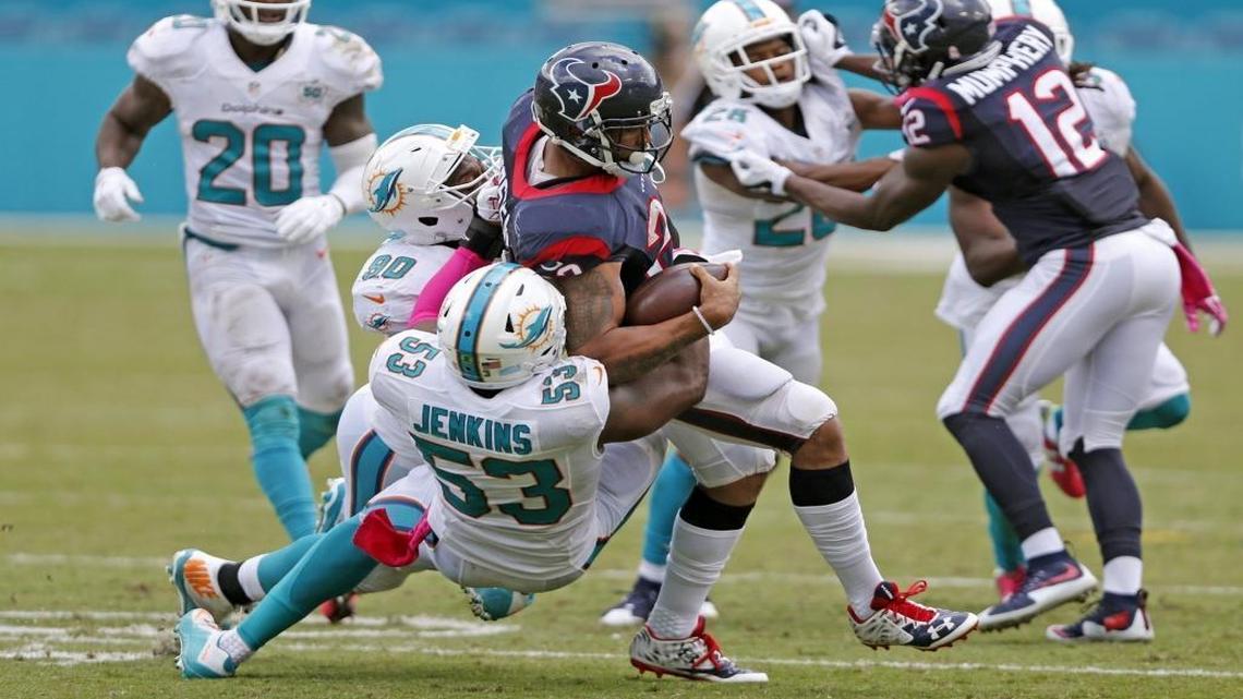 Former Houston Texans running back Arian Foster, center, signed a one-year contract with the Dolphins Monday after working out with the team earlier in the day.