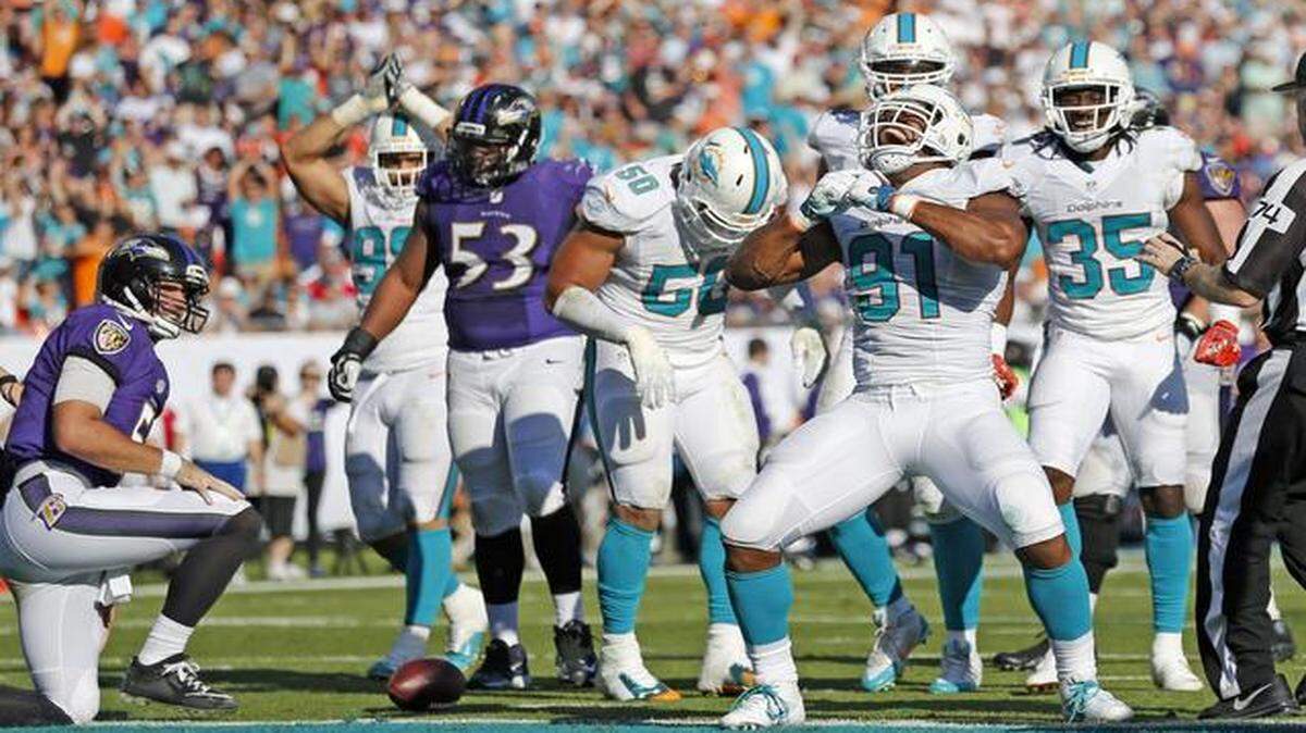 
Miami Dolphins defensive end Cameron Wake (91) reacts after sacking Baltimore Ravens quarterback Joe Flacco (5) just outside the end zone in the third quarter as the Miami Dolphins host the Baltimore Ravens at Sun Life Stadium in Miami Gardens on Dec. 7, 2014
