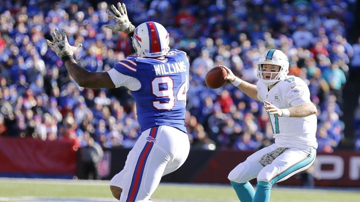 Miami Dolphins quarterback Ryan Tannehill (17) scrambles in the backfield as Buffalo Bills defensive end Mario Williams (94) defends in the first quarter as the Buffalo Bills host the Miami Dolphins at Ralph Wilson Stadium, Orchard Park, N.Y. on Sunday, November 8, 2015.