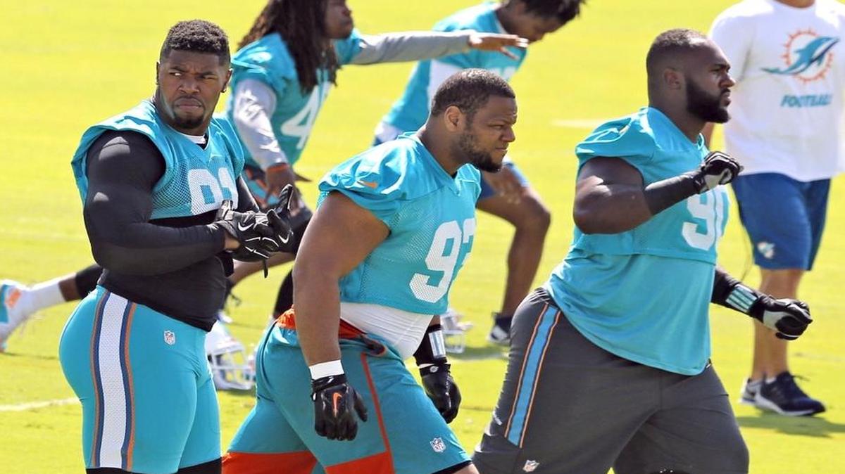 Miami Dolphins defensive end Cameron Wake (91) defensive tackle Ndamukong Suh (93) and defensive tackle Earl Mitchell (90) during Dolphins mini-camp at Doctors Hospital Training Facility at Nova Southeastern University on Wed., June 15, 2016