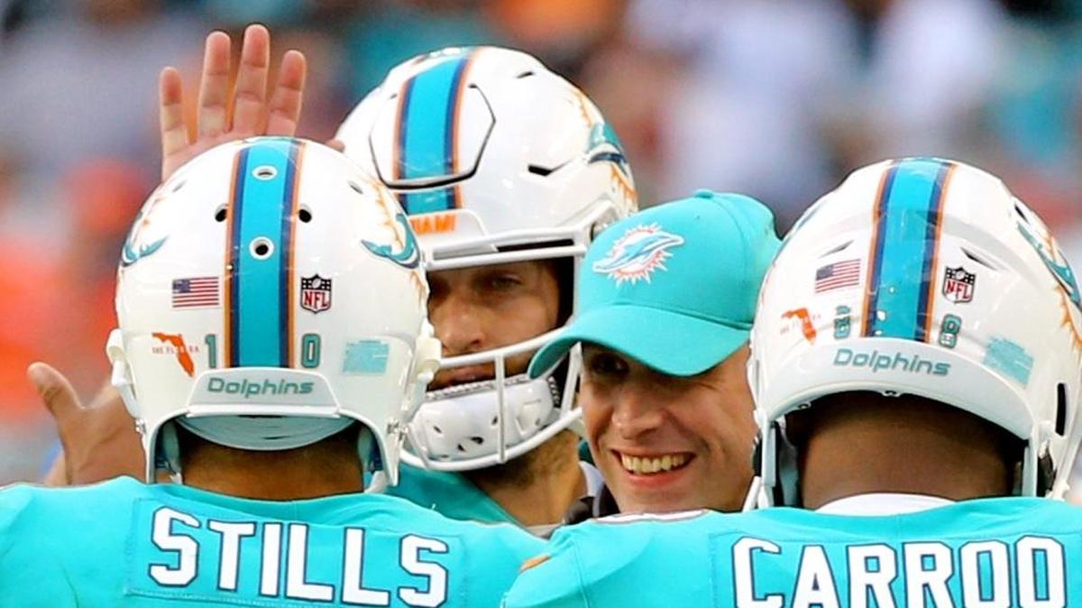 Miami Dolphins coach Adam Gase smiles at WR Kenny Stills after Stills caught a fourth quarter touchdown as hey play the Denver Broncos at Hard Rock Stadium in Miami Gardens, Florida, Dec. 3, 2017.
